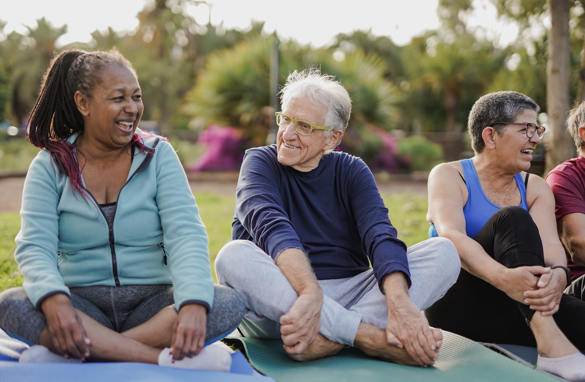 Happy elderly multiracial people having fun together after yoga class at city park - Joyful senior and friendship concept